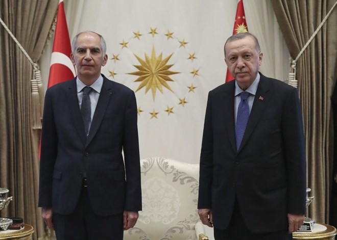 In this Aug. 19, 2020 file photo, Frence ambassador to Turkey Herve Magro, left, and Turkey's President Recep Tayyip Erdogan pose for photographs after the new ambassador presented his letter of credentials, in Ankara, Turkey. France recalled its ambassador to Turkey for consultations after Erdogan said Saturday, Oct. 24 French President Emmanuel Macron needed mental health treatment and made other comments that the French government described as unacceptably rude.(Turkish Presidency via AP, Pool)