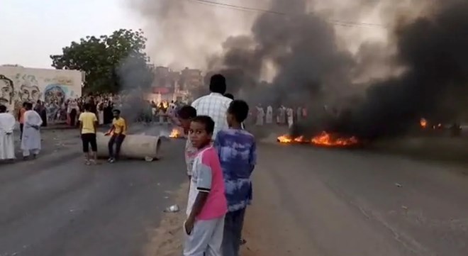 People gather on the streets of Khartoum Monday. Sudan's main pro-democracy group urged people to take to the streets to counter the apparent military coup. (RASD Sudan Network/Reuters)